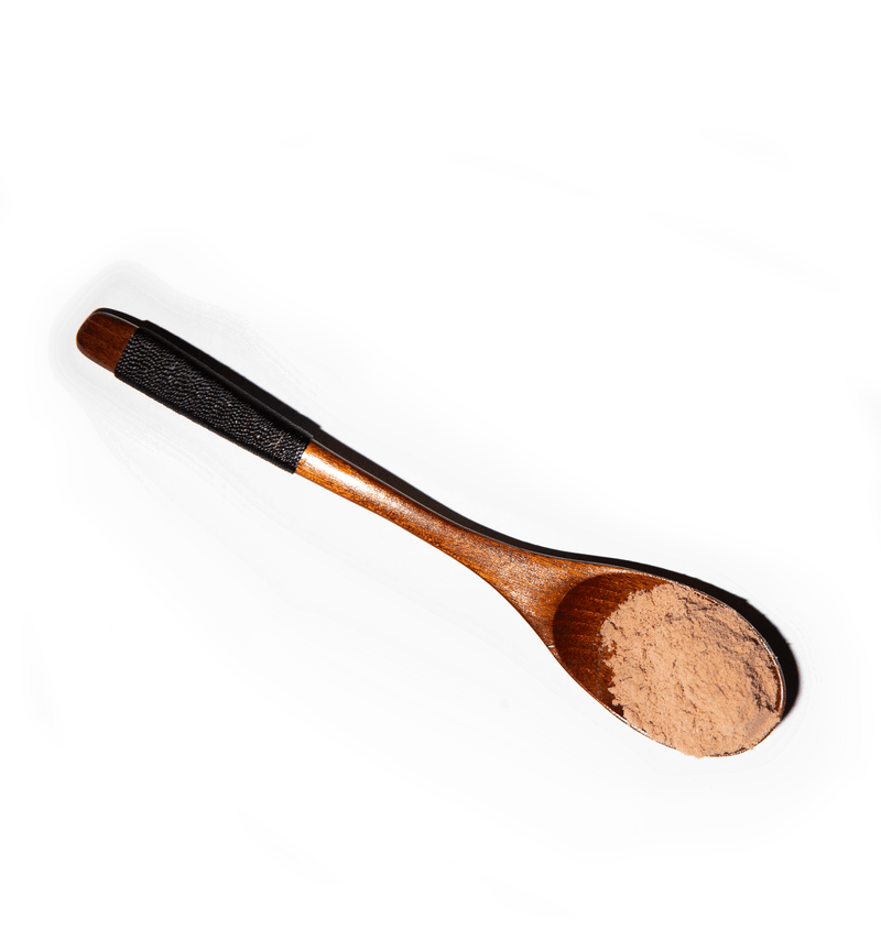 wooden spoon with brown coffee alternative mushroom powder